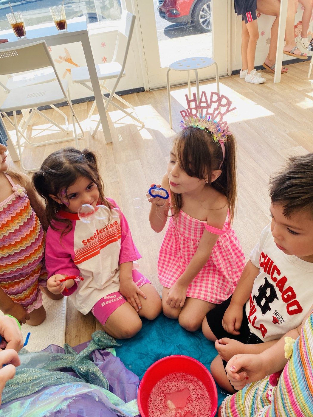 Birthday girl in a crown with friends in a circle