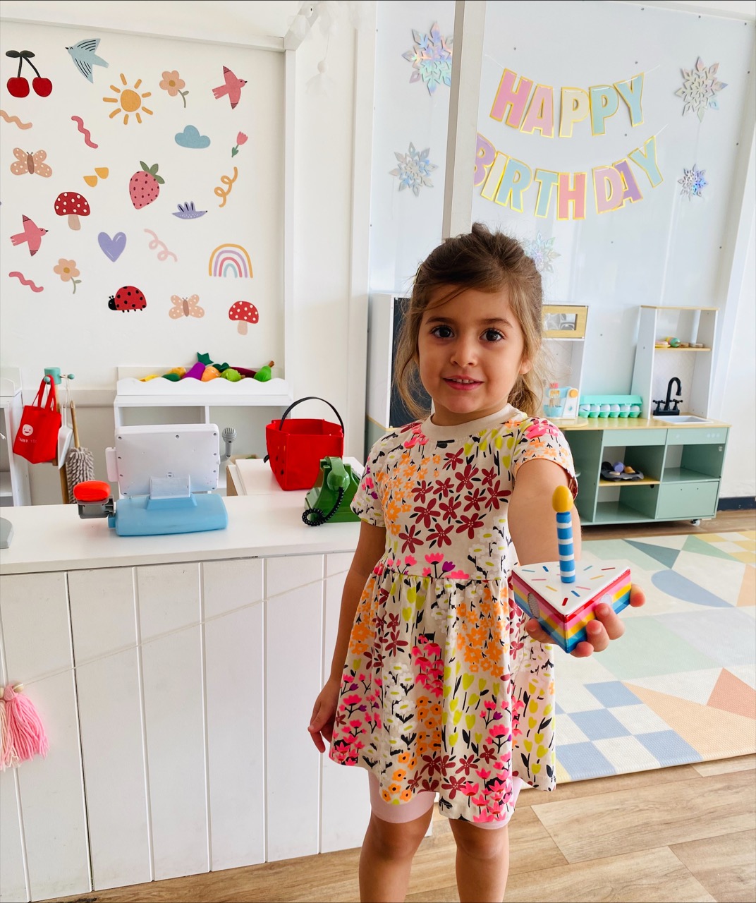 Child celebrating in the B.Curious play space