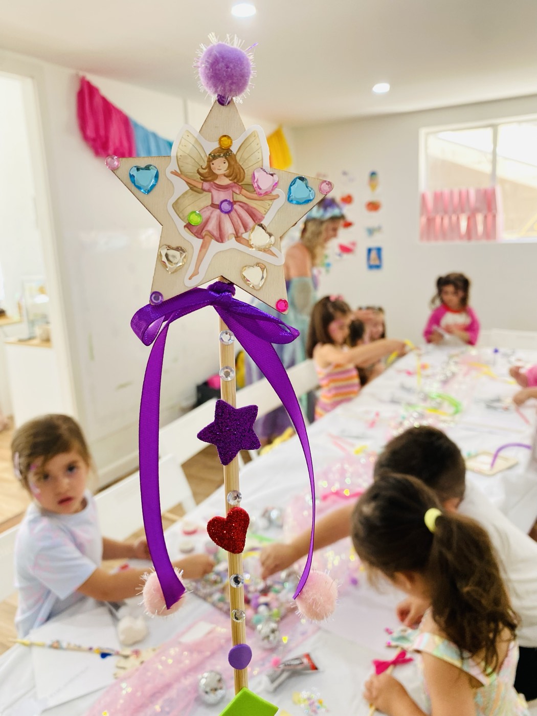 Children crafting at a styled birthday party table